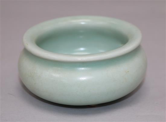 A Chinese Celadon glazed tripod censer